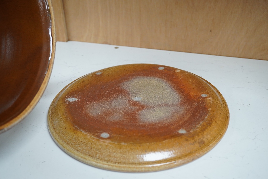 A Michael Mosse Llanbrynmair Pottery cheese dish and cover, incised and painted with dancing pigs, impressed marks, dish 23cm diameter.